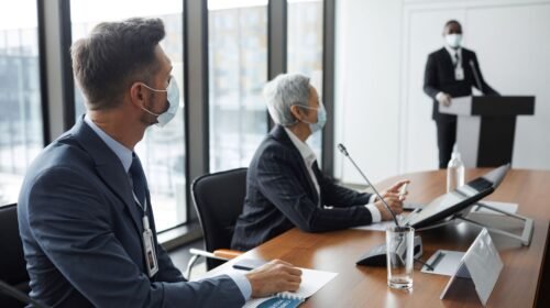 IBM employees collaborating in a hybrid office setting during a strategy meeting