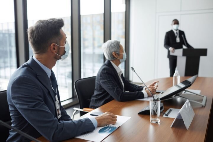 IBM employees collaborating in a hybrid office setting during a strategy meeting