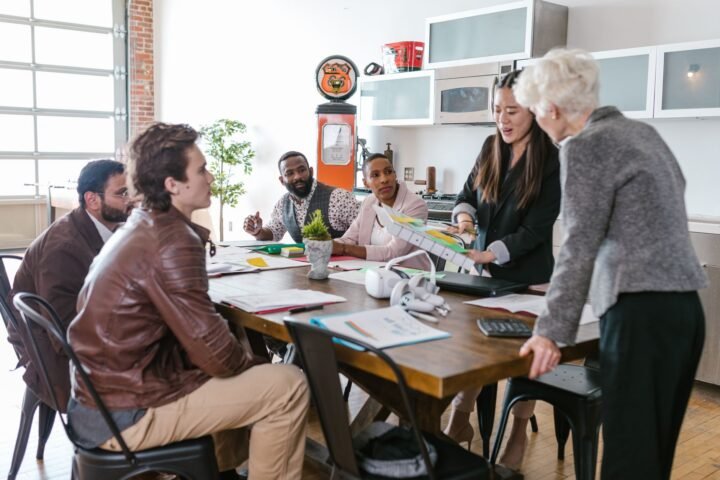 Team of professionals discussing Ramp's fintech scaling strategy around a conference table